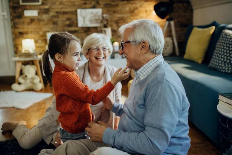 Cute small girl spending time with her grandparents